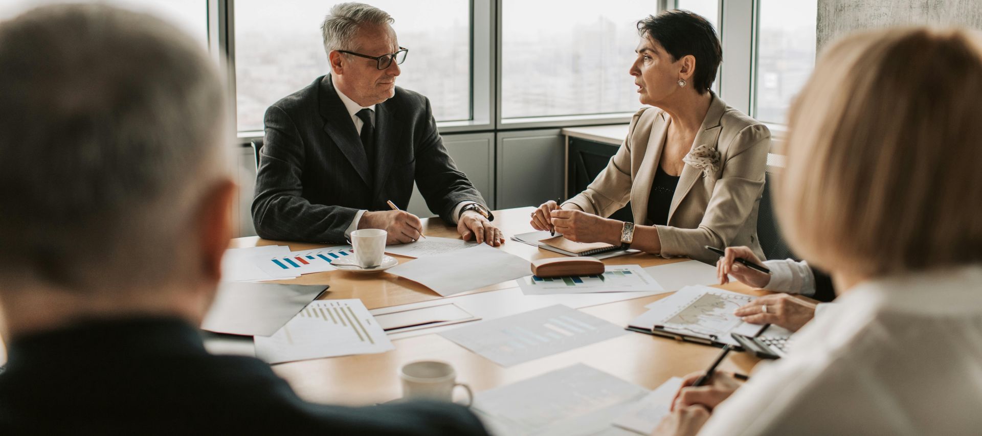 Elderly Man and Woman Discussing Business in a Meeting